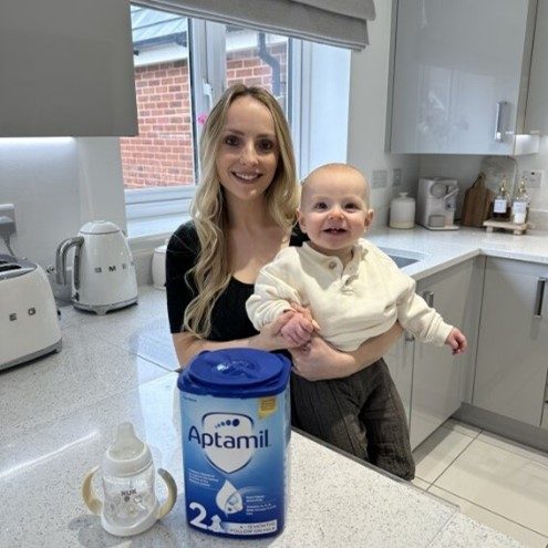mom holding baby in kitchen